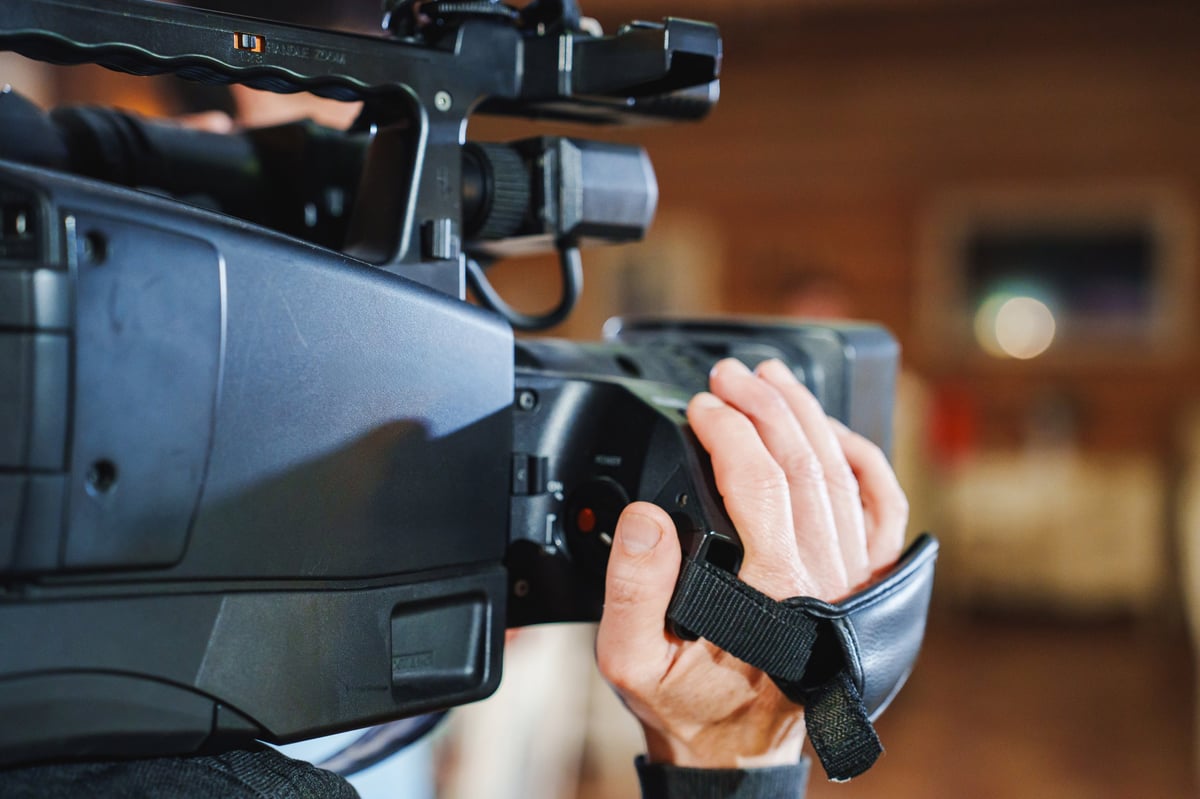 Filmmaker operating a professional video camera on set